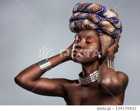 Black woman in traditional turban, fashion and beauty with makeup isolated on studio background. Natural cosmetics, confidence and female model with African head wrap, cosmetic glow and style Black woman in traditional turban, fashion and beauty with makeup isolated on studio background. Natural cosmetics, confidence and female model with African head wrap, cosmetic glow and style 134170432
