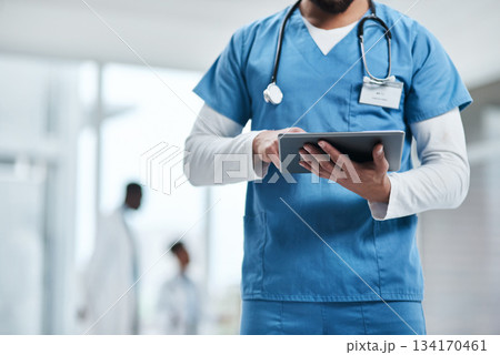 Hospital, doctor hands and tablet with a man in a clinic reading healthcare and wellness data. Employee, nurse and Male person with digital and health results on technology with research analysis Hospital, doctor hands and tablet with a man in a clinic reading healthcare and wellness data. Employee, nurse and Male person with digital and health results on technology with research analysis 134170461