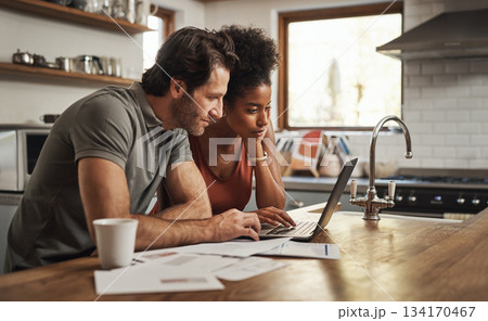 Laptop, couple and financial planning in a kitchen with documents for budget, savings and paying bills. Interracial, online and people with paperwork for taxes, mortgage and home loan application Laptop, couple and financial planning in a kitchen with documents for budget, savings and paying bills. Interracial, online and people with paperwork for taxes, mortgage and home loan application 134170467