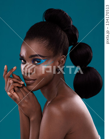 Portrait, beauty and cosmetics with a model black woman in studio on a blue background for hair or fashion. Face, makeup and haircare with an attractive young female person posing for haircare Portrait, beauty and cosmetics with a model black woman in studio on a blue background for hair or fashion. Face, makeup and haircare with an attractive young female person posing for haircare 134170513