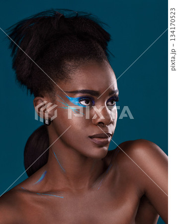 Thinking, natural hair and makeup with a black woman in studio on a blue background for beauty. Idea, haircare and cosmetics with an attractive young female model at the salon for fashion or styling 134170523
