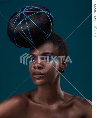 Idea, hair care and makeup with a model black woman in studio on a blue background for beauty. Thinking, fashion and cosmetics with an attractive young female person at the salon for a hairstyle 134170549