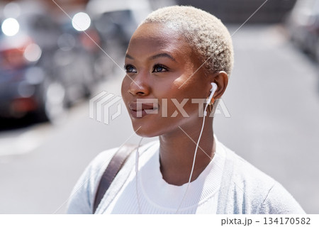 Music, vision and travel with a black woman in the city, thinking about future opportunity during the day. Mindset, idea and tourism with a young female traveler streaming audio in an urban town 134170582
