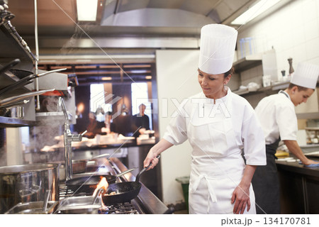 Chef, woman and frying in restaurant kitchen, catering service and prepare food for fine dining. Professional, cooking and female person saute meat with cook pan making meal nutrition for hospitality Chef, woman and frying in restaurant kitchen, catering service and prepare food for fine dining. Professional, cooking and female person saute meat with cook pan making meal nutrition for hospitality 134170781