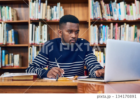 Library, laptop and university student with research, learning and planning for exam, report or focus on computer, studying or education. Black man, college and working on task, essay or scholarship Library, laptop and university student with research, learning and planning for exam, report or focus on computer, studying or education. Black man, college and working on task, essay or scholarship 134170891