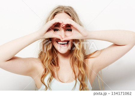 Portrait, smile and woman with heart shape, care and confident girl isolated against a white studio background. Face, female person and model with symbol for love, happiness and support with beauty Portrait, smile and woman with heart shape, care and confident girl isolated against a white studio background. Face, female person and model with symbol for love, happiness and support with beauty 134171062