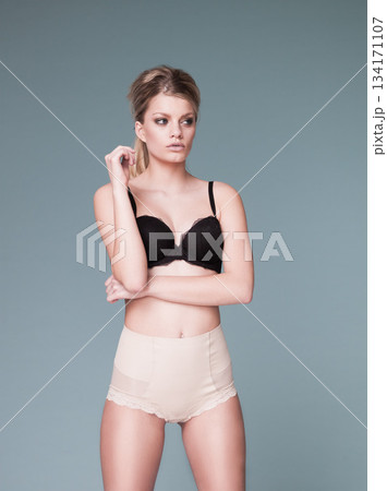 Mockup, sexy and woman with lingerie, beauty and confident girl against a grey studio background. Female person, lady and model with underwear. confidence and wellness with ideas, wellness and 134171107
