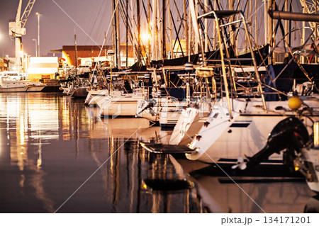 Boat, sunset and yacht on water in harbor for traveling, luxury cruise and sea transport at night. Transportation, marine vessel and boating club port for adventure, journey and sailing on ocean Boat, sunset and yacht on water in harbor for traveling, luxury cruise and sea transport at night. Transportation, marine vessel and boating club port for adventure, journey and sailing on ocean 134171201