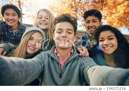 Teenager, group of friends and selfie in park, nature or fall trees and teens smile, picture of friendship and happiness for social media. Portrait, face and diverse people together for autumn photo Teenager, group of friends and selfie in park, nature or fall trees and teens smile, picture of friendship and happiness for social media. Portrait, face and diverse people together for autumn photo 134171216
