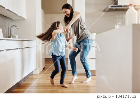 Happy, dance and a child with a mother in the kitchen, bonding and quality time together. Smile, laughing and a mom teaching her daughter with dancing, love and happiness with fun in a house Happy, dance and a child with a mother in the kitchen, bonding and quality time together. Smile, laughing and a mom teaching her daughter with dancing, love and happiness with fun in a house 134171312