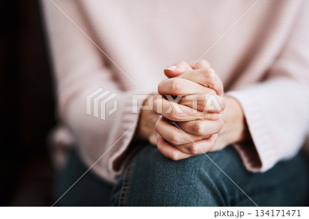 Woman, hands together and closeup with stress and anxiety in therapy for psychology crisis. Pray, mental health and problem with hand of a female patient scared with depression at counselling on sofa 134171471
