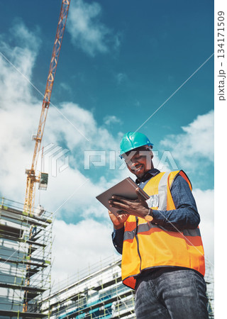 Engineer man, construction and a tablet for project management, development and architecture. Happy African male contractor with mobile app for engineering and safety inspection or planning outdoor Engineer man, construction and a tablet for project management, development and architecture. Happy African male contractor with mobile app for engineering and safety inspection or planning outdoor 134171509