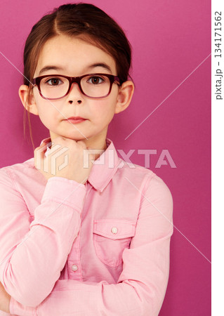 Girl child in portrait, glasses and thinking with questioning expression, smart and vision isolated on pink background. Intelligent, geek or nerd with female kid in studio, thoughtful in eyewear 134171562