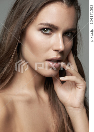 Sensual, beauty and portrait of woman in studio for wellness, facial treatment and self care. Seductive, skincare and female person with natural cosmetics, makeup and satisfaction on gray background 134171592
