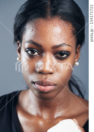 Portrait, boxing and a woman sweating in studio on a gray background for self defense, fitness or training. Face, exercise and workout with a black female boxer practising for a fighting competition Portrait, boxing and a woman sweating in studio on a gray background for self defense, fitness or training. Face, exercise and workout with a black female boxer practising for a fighting competition 134171722