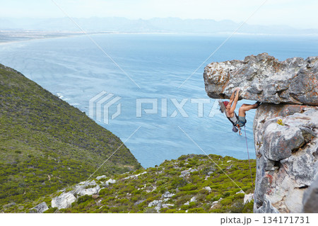 rock climbing, mountain and a woman hanging on a cliff with rope for adventure, travel and risk in nature. Female person outdoor for sports challenge, adrenaline and exercise for fitness in mountains 134171731