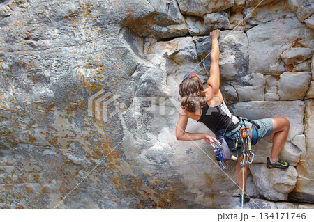 Rock climbing, fitness and challenge with woman on mountain for adventure and travel with space. Strong, freedom and hiking with female climber training in nature for courage, safety and workout Rock climbing, fitness and challenge with woman on mountain for adventure and travel with space. Strong, freedom and hiking with female climber training in nature for courage, safety and workout 134171746