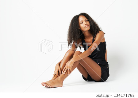 Fashion, beauty and portrait of African woman on floor of studio with trendy, stylish and casual clothes. Style, mockup and female person with confidence, attitude and beautiful on white background Fashion, beauty and portrait of African woman on floor of studio with trendy, stylish and casual clothes. Style, mockup and female person with confidence, attitude and beautiful on white background 134171768