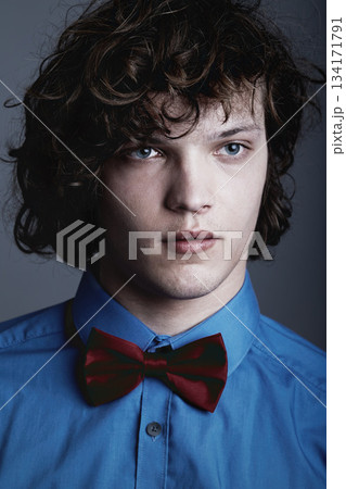Fashion, face of man in shirt and bow tie on studio background with aesthetic geek style and serious expression. Elegant beauty, formal and unique nerd clothes on gen z male model on grey backdrop. 134171791
