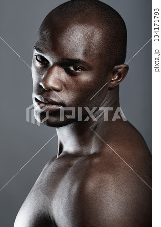 Beauty, serious portrait of black man and studio background with muscle fitness and skin glow aesthetic. Health, wellness and face of sexy African bodybuilder or male model isolated on grey backdrop. 134171793