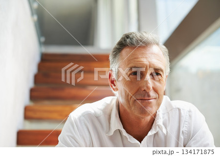 Thinking, steps and man in retirement at home with memories and sitting. Memory, relax and mature male person in a household alone with ideas and day dreaming about future and past in a house 134171875