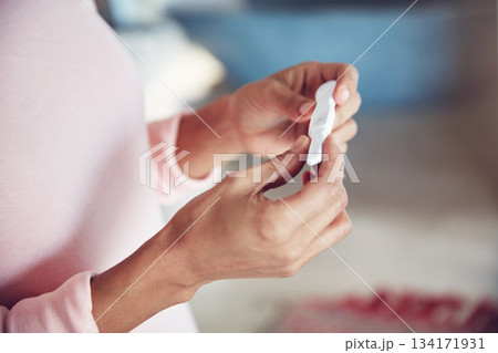 Closeup, hand and woman with a pregnancy test, waiting for the results and wellness at home. Zoom, female person and lady with expectation, pregnant and future maternity with fertility treatment Closeup, hand and woman with a pregnancy test, waiting for the results and wellness at home. Zoom, female person and lady with expectation, pregnant and future maternity with fertility treatment 134171931
