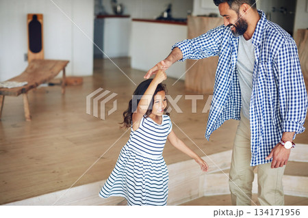 Family, father and girl dance, home and happiness with love, bonding and movement in the lounge. Male parent, female child and daughter with dad, kid and dancing for fun, playful and loving together 134171956