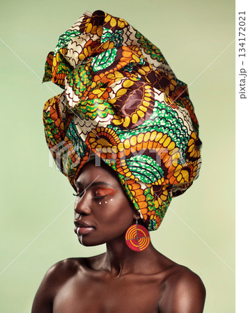 Beauty, black woman and fashion cosmetics with African head wrap and makeup with mockup. Isolated, green background and young female person with a traditional hair scarf with confidence feeling relax Beauty, black woman and fashion cosmetics with African head wrap and makeup with mockup. Isolated, green background and young female person with a traditional hair scarf with confidence feeling relax 134172021