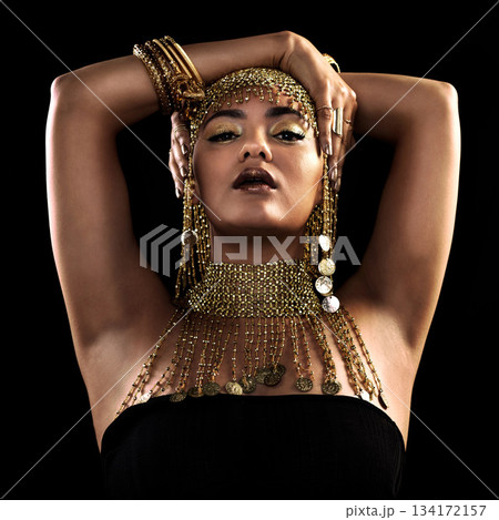 Fashion, portrait and woman in studio with gold, beauty and royal, jewellery or attitude on black background. Face, queen and lady model pose in luxury accessory for cosplay, rich or aesthetic makeup Fashion, portrait and woman in studio with gold, beauty and royal, jewellery or attitude on black background. Face, queen and lady model pose in luxury accessory for cosplay, rich or aesthetic makeup 134172157