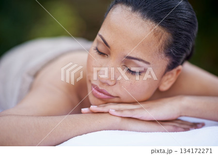 Sleep, relax and a woman on a spa bed for a massage, luxury relaxation and wellbeing in nature. Relax, calm and a young lady sleeping after a skin treatment, pampering and wellness in a garden 134172271