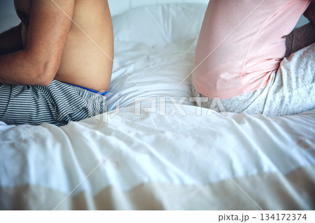Fight, anger and a couple on a bed for conflict, marriage problem and frustrated in relationship. Ignoring, space and a man and woman sitting in the bedroom with frustration and disagreement 134172374