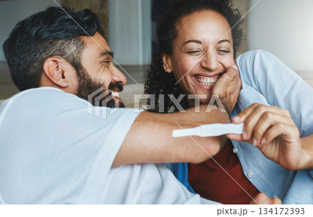 Happy couple, excited and smile for pregnancy test together for happiness, laughing and excitement. Love, funny and a man and pregnant woman looking excited and reading results for a baby at home Happy couple, excited and smile for pregnancy test together for happiness, laughing and excitement. Love, funny and a man and pregnant woman looking excited and reading results for a baby at home 134172393