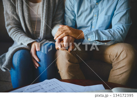 Holding hands, senior couple and life insurance support with paperwork in a living room. Home, anxiety and elderly people with empathy, stress and trust with solidarity for bills and tax problem Holding hands, senior couple and life insurance support with paperwork in a living room. Home, anxiety and elderly people with empathy, stress and trust with solidarity for bills and tax problem 134172395
