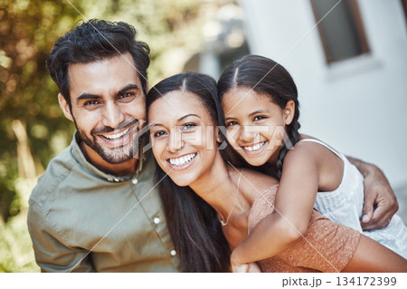 Happy family, nature and portrait together with smile in a garden or backyard of a house. Love, quality time and a father, mother and girl child with piggyback in a park for happiness and bonding 134172399