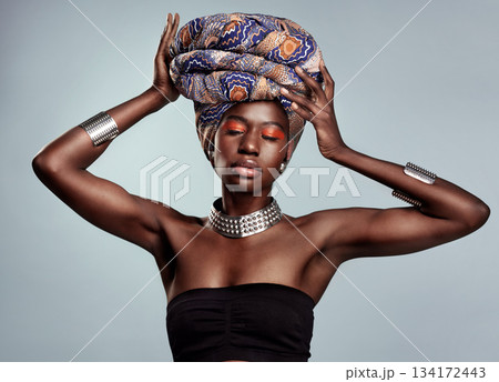 African fashion, makeup and black woman in studio on white background with luxury, cosmetics and beauty. Glamour, luxury and face of female person glow in exotic jewelry, traditional style and scarf 134172443