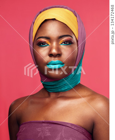 Bold makeup, headwrap and portrait of a black woman isolated on a pink background in a studio. Bright, color and headshot of an African model with headwear and cosmetics for culture and lifestyle Bold makeup, headwrap and portrait of a black woman isolated on a pink background in a studio. Bright, color and headshot of an African model with headwear and cosmetics for culture and lifestyle 134172468