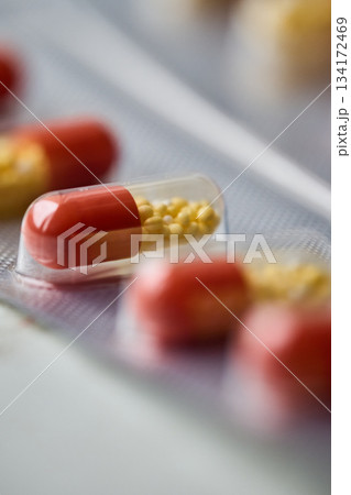 Capsules are arranged in a package on a table. Capsules are arranged in a package on a table. 134172469