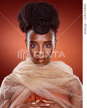Portrait, fashion and black woman with beauty, stylish and confident lady against a red studio background. Face, female person and model with glamour, glow and elegant with trendy, style and culture 134172603