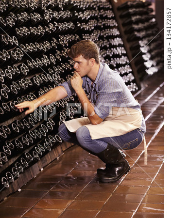 Winery, man and counting bottles of wine in cellar, warehouse or factory. Alcohol, manufacturing and male person count, inspection or quality control at production plant or distillery while thinking. Winery, man and counting bottles of wine in cellar, warehouse or factory. Alcohol, manufacturing and male person count, inspection or quality control at production plant or distillery while thinking. 134172857