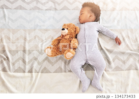 Top view, teddy bear and baby sleeping in bedroom for rest, nap time and dreaming in nursery. Childcare, newborn and cute, tired and African child with toy in bed for comfort, relax and calm at home Top view, teddy bear and baby sleeping in bedroom for rest, nap time and dreaming in nursery. Childcare, newborn and cute, tired and African child with toy in bed for comfort, relax and calm at home 134173433