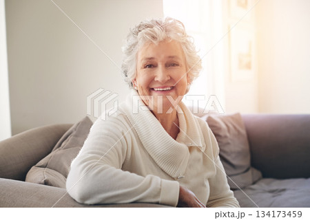 Relax, happy and portrait of old woman on sofa for free time, retirement and weekend. Smile, happiness and mindset with senior person in living room at home for elderly, positive and carefree 134173459