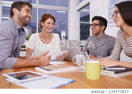 Team laughing together, creative people in meeting with collaboration and project planning in conference room. Brainstorming, teamwork with young men and women in strategy discussion in workplace 134173627