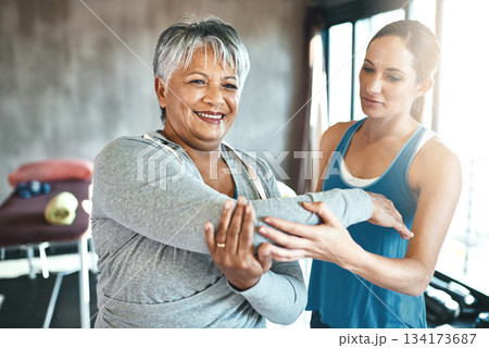 Stretching, support and old woman with personal trainer for fitness, wellness or rehabilitation. Health, workout or retirement with senior patient and female trainer in gym for arm warm up training Stretching, support and old woman with personal trainer for fitness, wellness or rehabilitation. Health, workout or retirement with senior patient and female trainer in gym for arm warm up training 134173687