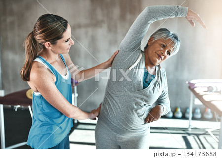 Stretching, help and old woman with personal trainer for fitness, wellness or rehabilitation. Health, workout or retirement with senior patient and female trainer in gym for warm up training Stretching, help and old woman with personal trainer for fitness, wellness or rehabilitation. Health, workout or retirement with senior patient and female trainer in gym for warm up training 134173688
