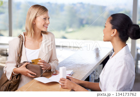 Shopping, happy and a woman buying skincare from a cashier for retail, service and care of skin. Smile, talking and a female customer speaking to a worker about a product after making a payment Shopping, happy and a woman buying skincare from a cashier for retail, service and care of skin. Smile, talking and a female customer speaking to a worker about a product after making a payment 134173762