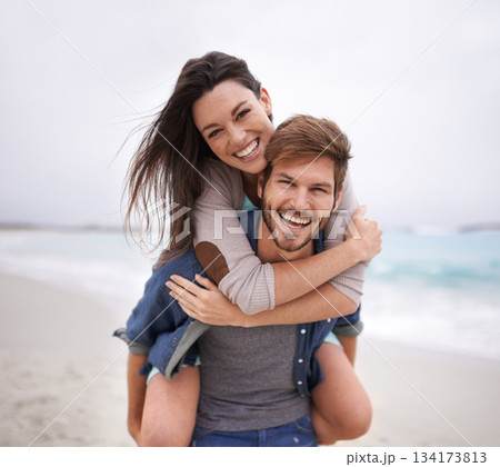 Couple, portrait and piggyback hug at beach for travel, romance and freedom together outdoors. Face, smile and happy woman embracing man on trip, vacation or holiday, bond and having fun in Florida Couple, portrait and piggyback hug at beach for travel, romance and freedom together outdoors. Face, smile and happy woman embracing man on trip, vacation or holiday, bond and having fun in Florida 134173813