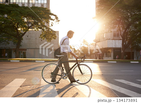 Commute, bike and business man in city for morning, travel and carbon footprint. Cycling, transportation and urban with male employee walking on crosswalk for journey, transit and professional Commute, bike and business man in city for morning, travel and carbon footprint. Cycling, transportation and urban with male employee walking on crosswalk for journey, transit and professional 134173891