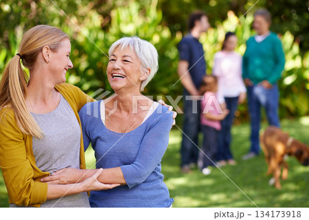 Family, mother and adult daughter hug outdoor, spending quality time in garden together with happiness and care. Happy women are content in relationship with love, laughter and carefree in nature 134173918