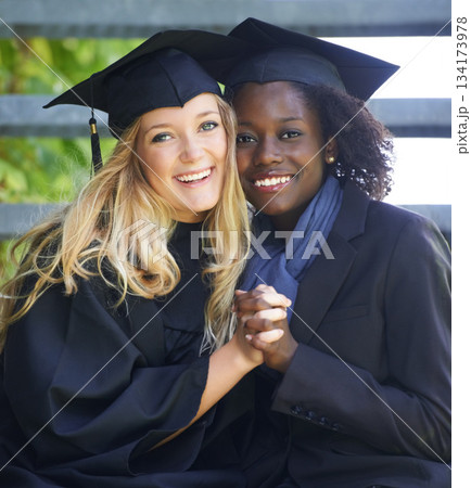 Portrait, graduation and women university friends holding hands on campus together as graduate students. Happy, smile and education with a female college student and her friend celebrating graduating Portrait, graduation and women university friends holding hands on campus together as graduate students. Happy, smile and education with a female college student and her friend celebrating graduating 134173978