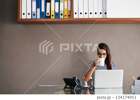 Coffee, laptop and business woman in an office for planning, management and checking email on wall background. Tea, relax and female manager online for project, proposal or creative idea research Coffee, laptop and business woman in an office for planning, management and checking email on wall background. Tea, relax and female manager online for project, proposal or creative idea research 134174051
